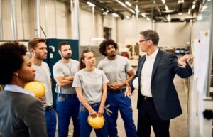 Company manager presenting business strategy to group of workers